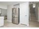 Modern kitchen features stainless steel refrigerator, white cabinets, and easy access to stairs at 2345 Cliffwood Dr, Henderson, NV 89074