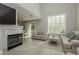 Bright living room features a fireplace, neutral decor and large windows at 2345 Cliffwood Dr, Henderson, NV 89074