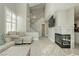 Inviting living room boasts a fireplace, staircase, and stylish, neutral-toned furnishings at 2345 Cliffwood Dr, Henderson, NV 89074