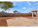 View of the backyard with a concrete patio, gravel landscaping, and block wall at 2407 Belt Buckley Dr, Henderson, NV 89002