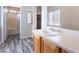 Bright bathroom featuring a vanity, mirror, and a shower-tub combo with sliding glass door at 2407 Belt Buckley Dr, Henderson, NV 89002