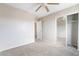 Clean bedroom with mirrored closet doors, neutral carpeting and a ceiling fan at 2407 Belt Buckley Dr, Henderson, NV 89002