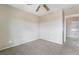 Neutral bedroom with a ceiling fan and neutral carpet, and an attached closet at 2407 Belt Buckley Dr, Henderson, NV 89002