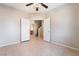Spacious bedroom features a tile floor, ceiling fan, and stairway access at 2407 Belt Buckley Dr, Henderson, NV 89002