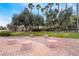 Community common area with mature trees, grass, and walkway with sitting area at 2407 Belt Buckley Dr, Henderson, NV 89002