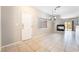 Open living room featuring tile floors, fireplace, and modern light fixture at 2407 Belt Buckley Dr, Henderson, NV 89002