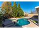 Inviting backyard pool and spa area with mature trees, a patio area, and privacy walls at 2461 Daks Loden Ct, Henderson, NV 89044