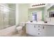 Bathroom features double sinks with white cabinets, a large mirror and shower with glass door at 25 Lone Cove Ct # 2, Henderson, NV 89012
