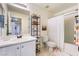 Well-lit bathroom with a single sink vanity, tile floors and a shower with a curtain at 25 Lone Cove Ct # 2, Henderson, NV 89012