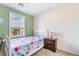 Bright bedroom with a twin bed, side table and window with shutters showing outside view at 25 Lone Cove Ct # 2, Henderson, NV 89012