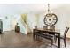 Open floorplan of dining room with a large clock, dark wood floors, and staircase at 25 Lone Cove Ct # 2, Henderson, NV 89012