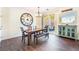 Bright dining room with sliding glass doors, modern chandelier, and dark wood floors at 25 Lone Cove Ct # 2, Henderson, NV 89012