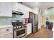 Charming kitchen features white cabinets, stainless steel appliances, and a tiled backsplash at 25 Lone Cove Ct # 2, Henderson, NV 89012