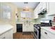 Cozy kitchen with white cabinets, stainless steel appliances, and wood-look floors at 25 Lone Cove Ct # 2, Henderson, NV 89012