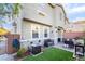 Outdoor patio features synthetic grass, brick pavers, grill, and seat with privacy wall at 25 Lone Cove Ct # 2, Henderson, NV 89012