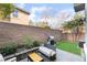 Outdoor patio features synthetic grass, brick pavers, grill and privacy wall at 25 Lone Cove Ct # 2, Henderson, NV 89012
