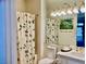 Bathroom featuring a floral shower curtain, mirrored wall and vanity at 2536 Faiss Dr, Las Vegas, NV 89134