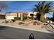 Charming single-story home showcasing a desert landscape, mature palm trees, and a welcoming two-car garage at 2536 Faiss Dr, Las Vegas, NV 89134