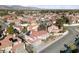 Gorgeous aerial perspective of a community boasting lush landscapes, vibrant red roofs, and mountain views at 2637 Ohio Ct, Las Vegas, NV 89128