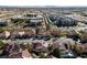 Beautiful aerial view of a suburban neighborhood featuring tree-lined streets, pools, and stunning mountain views at 2637 Ohio Ct, Las Vegas, NV 89128