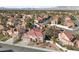 Breathtaking aerial view showcasing an established neighborhood with lush landscaping, pools, and mountain views at 2637 Ohio Ct, Las Vegas, NV 89128