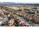 Serene aerial shot of a residential community with pools, solar panels, and nearby commercial development at 2637 Ohio Ct, Las Vegas, NV 89128