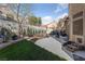 Landscaped backyard with turf, paving, grill, and picnic table for entertaining at 2637 Ohio Ct, Las Vegas, NV 89128