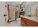 Bathroom with a glass-enclosed shower, granite countertop vanity, and decorative wall accents at 2637 Ohio Ct, Las Vegas, NV 89128