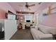 Bedroom with a sofa, TV, desk and custom shelving is ideal for relaxation and productivity at 2637 Ohio Ct, Las Vegas, NV 89128