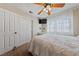 Well-lit bedroom featuring a comfy bed, ceiling fan, mounted TV, and a large closet for ample storage at 2637 Ohio Ct, Las Vegas, NV 89128