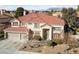 Two-story home with a well-manicured front yard and a three-car garage at 2637 Ohio Ct, Las Vegas, NV 89128