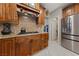 Updated kitchen featuring a gas cooktop, wooden cabinetry, and stainless steel appliances at 2637 Ohio Ct, Las Vegas, NV 89128