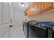 Laundry room featuring updated appliances and wooden cabinetry with plenty of storage space at 2637 Ohio Ct, Las Vegas, NV 89128