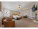 Bright main bedroom with sitting area, ceiling fan, fireplace and neutral decor for a relaxing atmosphere at 2637 Ohio Ct, Las Vegas, NV 89128