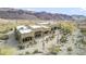 Stunning aerial view of custom home with desert landscaping and mountain views at 26425 Park St, Nelson, NV 89005