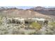 An aerial view of the property surrounded by natural desert vegetation and mountains at 26425 Park St, Nelson, NV 89005