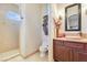 Bathroom featuring tiled walk-in shower and vessel sink with wood vanity at 26425 Park St, Nelson, NV 89005