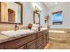 Double vanity sink and a soaking tub in a Primary bathroom at 26425 Park St, Nelson, NV 89005