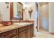 Bathroom featuring stone shower, dark wood cabinets and granite countertop at 26425 Park St, Nelson, NV 89005