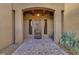 Inviting front entrance with stone walkway, wooden door, and desert plants at 26425 Park St, Nelson, NV 89005