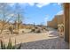 Beautiful desert landscaping leading to the home's entrance with a paved walkway at 26425 Park St, Nelson, NV 89005