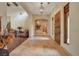 A spacious hallway features decorative doors, travertine flooring, and comfortable seating at 26425 Park St, Nelson, NV 89005
