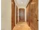 Hallway featuring wooden doors and tan tile flooring at 26425 Park St, Nelson, NV 89005