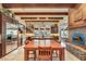 A well-lit kitchen features wood beam ceiling accents, stainless steel appliances, and ample counter space at 26425 Park St, Nelson, NV 89005