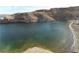 Tranquil lake view showcasing the clear water and rocky shoreline at 26425 Park St, Nelson, NV 89005