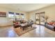 Comfortable living room features travertine floors, leather furniture, and mountain views at 26425 Park St, Nelson, NV 89005
