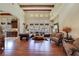 Spacious living room featuring a large window array, hardwood floors, and beamed ceilings at 26425 Park St, Nelson, NV 89005