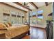 A spacious bedroom includes hardwood floors, beamed ceilings, and many windows for natural light at 26425 Park St, Nelson, NV 89005