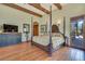 This large bedroom has a wood floor, a beamed ceiling, and a door to the outside at 26425 Park St, Nelson, NV 89005