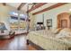 Large bedroom has wood floors, wood beam ceilings, and many windows for natural light at 26425 Park St, Nelson, NV 89005